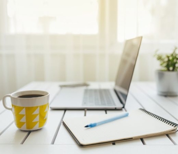 mug and laptop and notebook