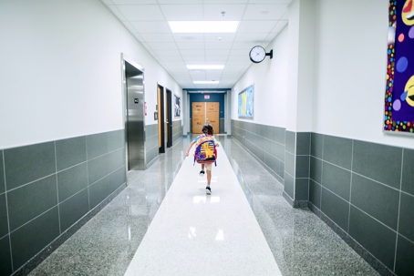 Boy Running In The School Hallway